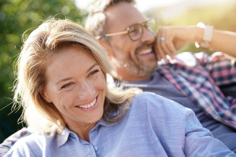 man and woman smiling while enjoying the sun
