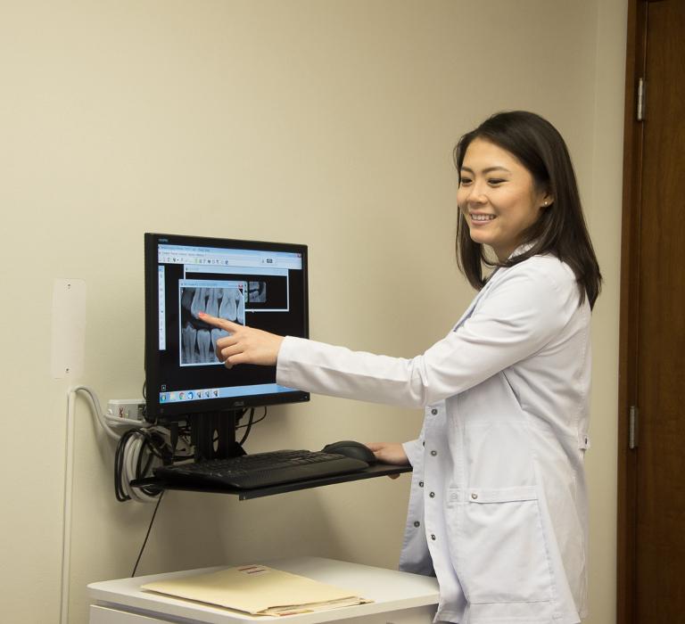 Dr Cao showing a patient their dental x-rays