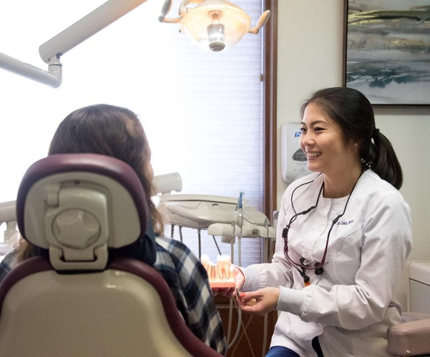 Dr. Cao talking to a patient about dental implants