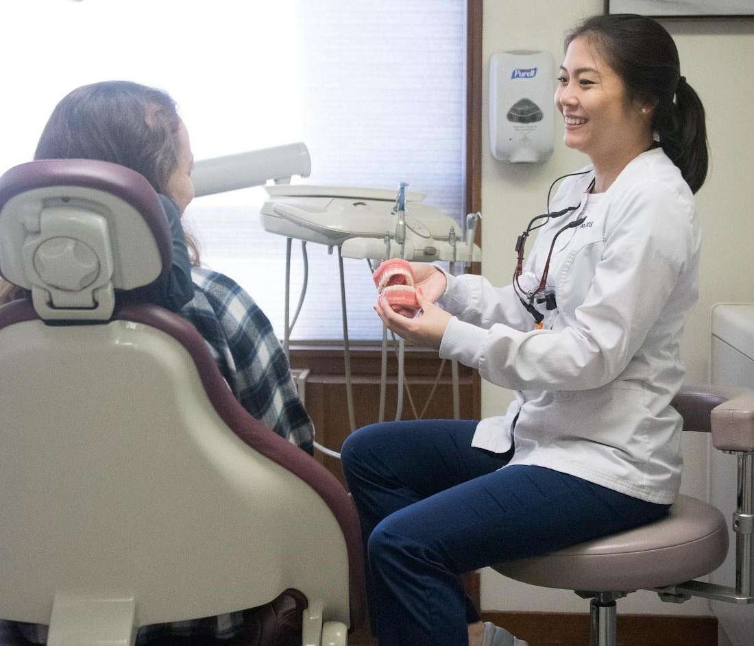 Dr. Hanna Cao Explaining Dental Care to patient At Wellesley Hills Dental