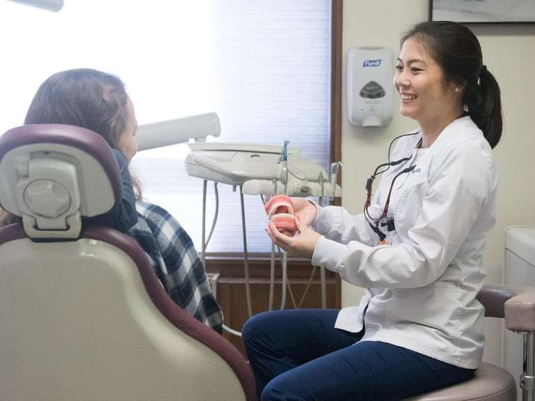 Dr cao howing a patient their digital impressions