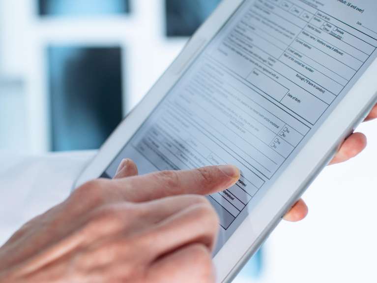 person holding digital dental records