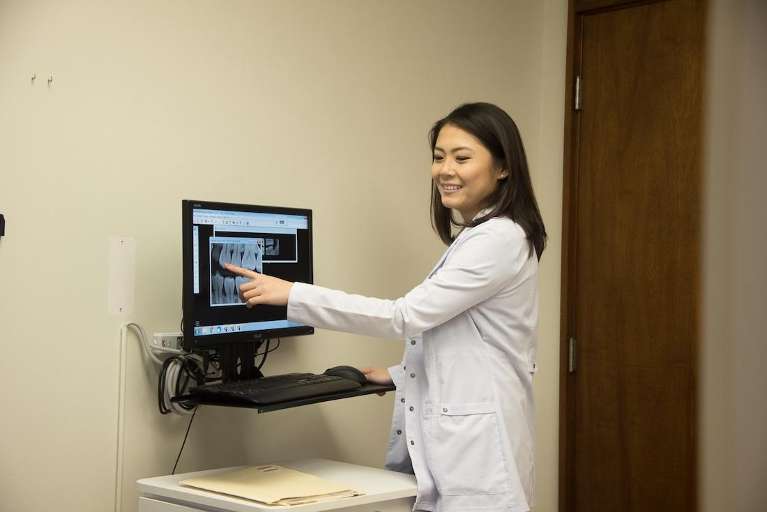 Dr. Hanna Cao showing a patient their dental x-ray