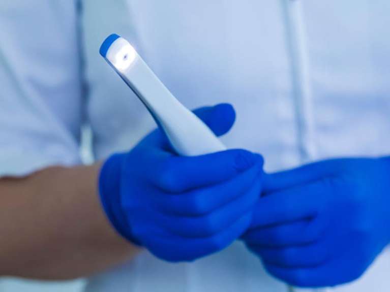 person holding Intraoral Camera